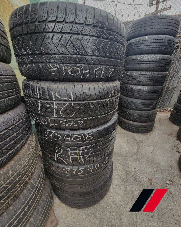 Tall columns of used tires with size chalk markings